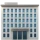 Gray office building with multiple windows and two entrance doors.